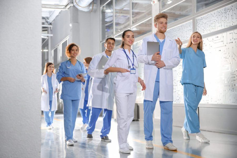 A group of travel nurses in Massachusetts walking in hospital