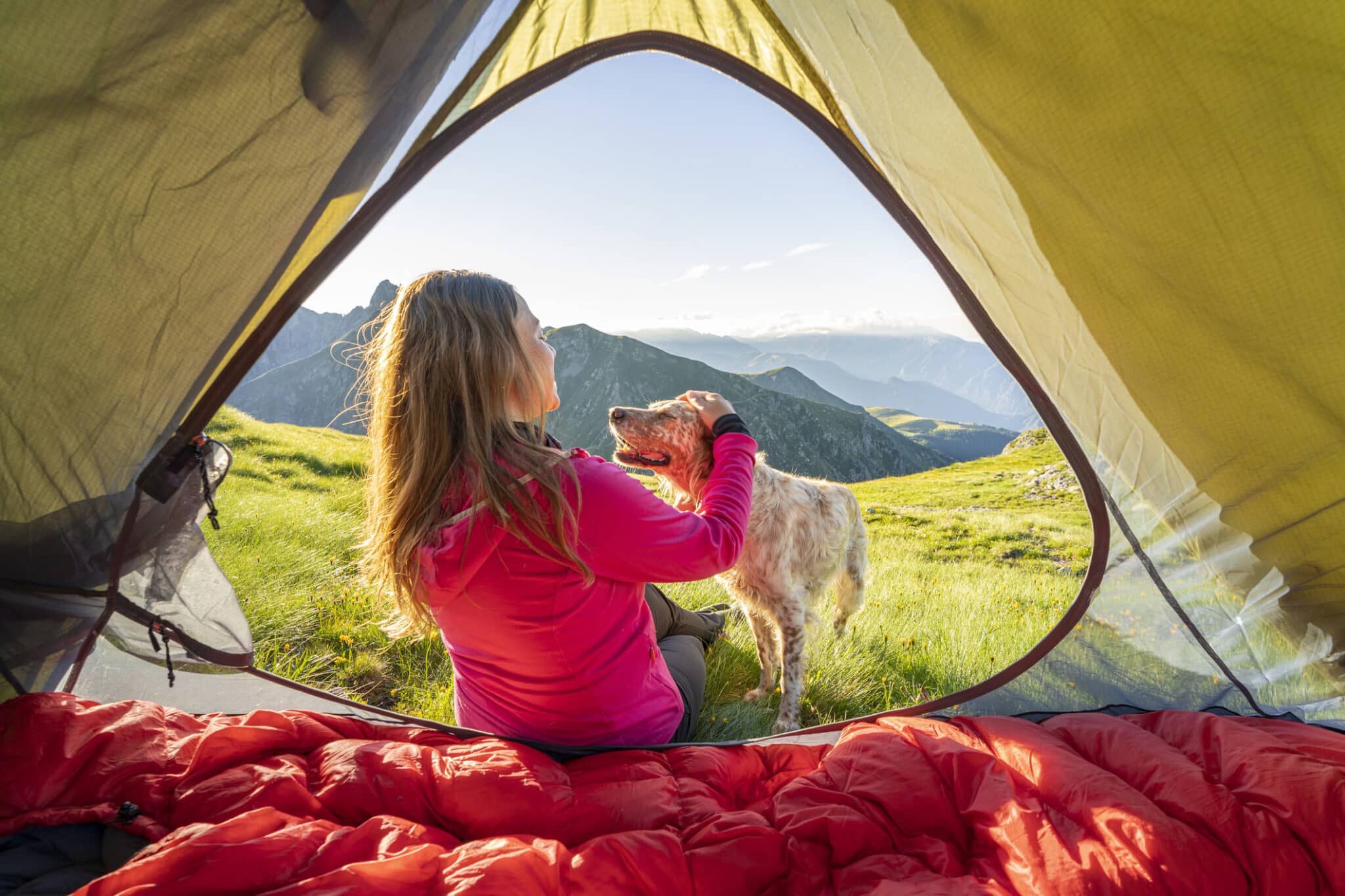 A labor & delivery travel nurse enjoying time off with her dog in a tent